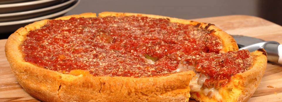 Chicago style deep dish pizza with a piece cut out
